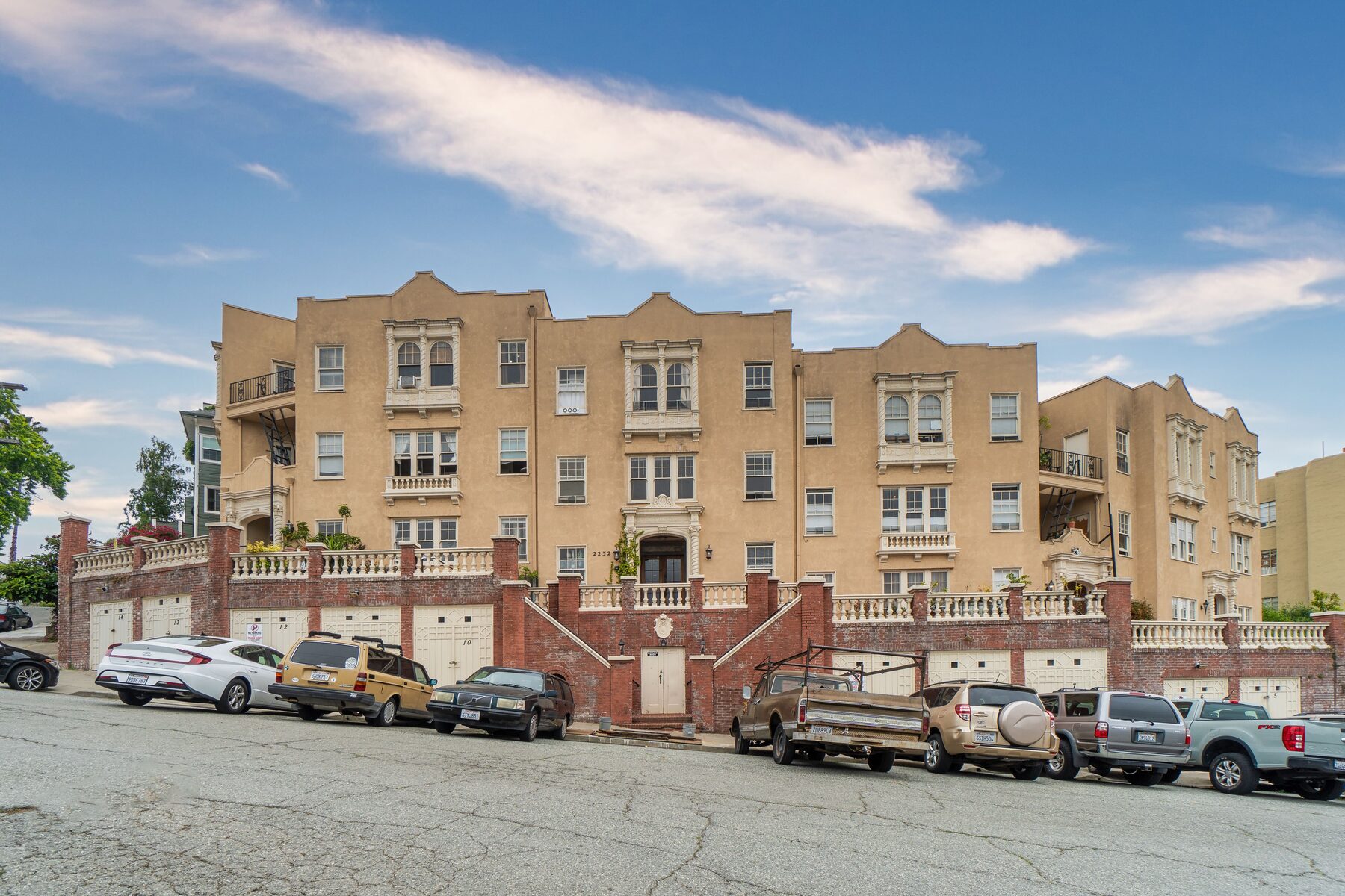 Mediterranean revival apartment building above a row of garages